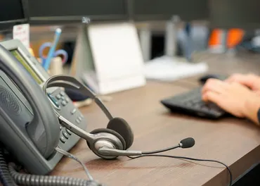 VoIP telephone and hands typing